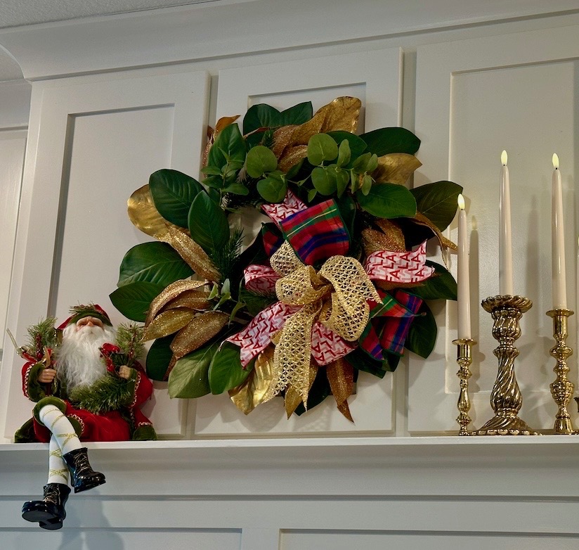 Magnolia wreath and brass candlesticks